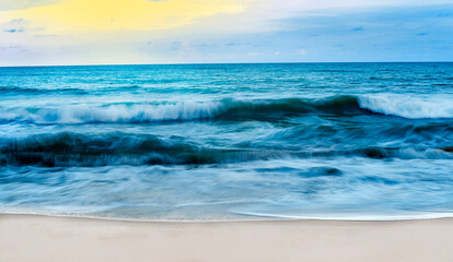 Beautiful sea wave on the sand beach in Sunset time
