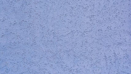 Background and texture of decorative rough plaster of light blue color close-up