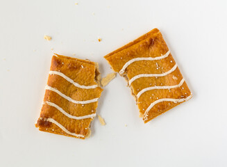 Broken cinnamon sugar toaster pastries with apple filling on a white background.