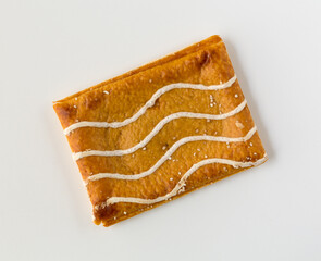 Single cinnamon sugar toaster pastry with icing on a white background.