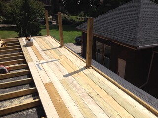 Construction of large wood deck on flat roof garage