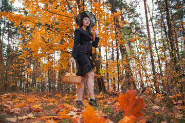 witch in the autumn forest. halloween cosplay. halloween fall holiday celebration