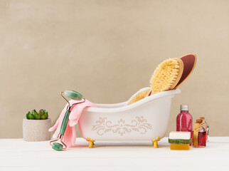 Bathroom and spa accessories.  body care concept. Organic massage brush for body massage, facial gua sha massage roller, aroma oil and sea salt.