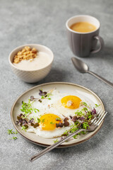 Healthy breakfast. Eggs with micro greens, granola with yogurt and coffee.