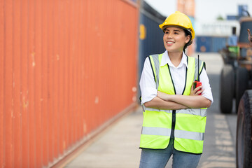 portrait factory worker or engineer holding walkie talkie in containers warehouse storage