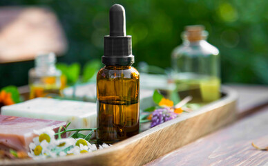 Aromatherapy essential oil bottle, herbal plants and oil