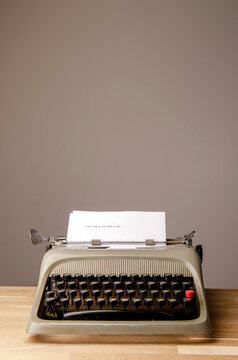 beautiful old typewriter on wooden slat table. From the brand olivetti