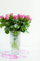 a bouquet of roses in a crystal vase