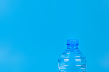 Top of a plastic water bottle on a blue background.