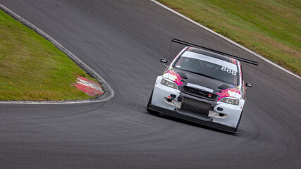 A shot of a racing car as it circuits a track.