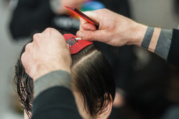 A man in a barbershop.Modern guy having his hair cut in barbershop