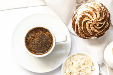 Dark chocolate and cocoa chocolate cupcakes with a cup of hot black coffee