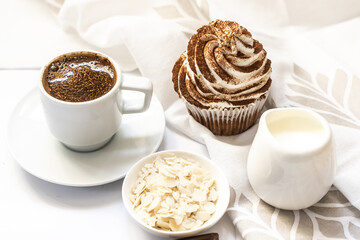 Dark chocolate and cocoa chocolate cupcakes with a cup of hot black coffee