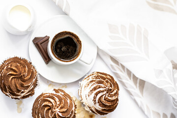 Dark chocolate and cocoa chocolate cupcakes with a cup of hot black coffee. Space for text