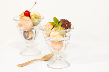 Close up of ice-cream in glass cup on white