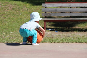 little child playing with a ball