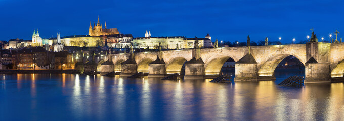 Scenic view on Prague Castle and the St. Vitus cathedral and historical center of Prague, buildings and landmarks of old town at sunrise or dusk, Prague, Czech Republic. Beautiful and romantic evening