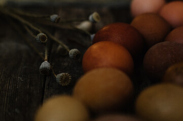brown eggs, eggs on wood, ester, dried flowers, dark colors, palette of eggs, ester is coming, rusty egg colors