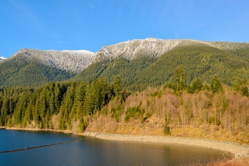 Fototapeta na wymiar Snow Mountains and Capilano Lake in Vancouver British Columbia Pacific Northwest.