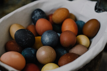 Fototapeta na wymiar easter basket, colorful eggs, easter holiday, dark colors for easter, original egg color