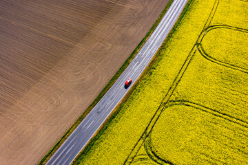 car driving in the fields of Saxony between Raps and empty field