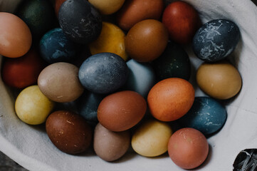 Fototapeta na wymiar easter basket, colorful eggs, easter holiday, dark colors for easter, original egg color