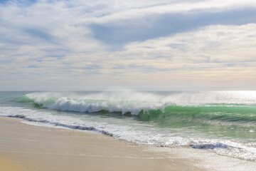 Set of pictures of a fantastic ocean wave in different stages. Cloudy sunrise sky. San Jose del Cabo. Mexico.