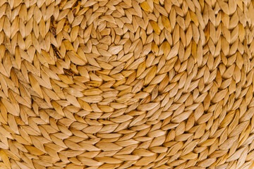 Wicker basket or interior decor close-up. The texture of weaving in a circle.