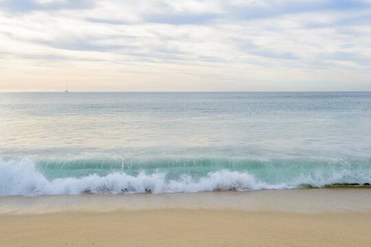 Set of six pictures of a fantastic ocean wave in different stages. Cloudy sunrise sky. San Jose del Cabo. Mexico.