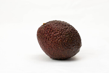 Two hass red avocado isolated on white.