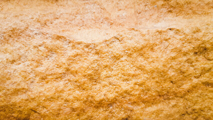 Stone texture brown color, close up view of the rock surface and details sandstone wall concept of wallpaper background or backdrop.