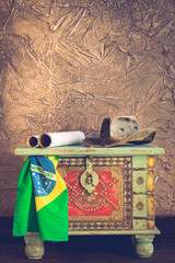 stylish pirate treasure chest with travel hat, old maps  and brazil flag Adventure and travel concept.