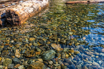 Pebbles under water background. Magnificent Seton Lake in Canada.