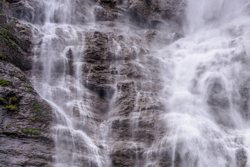 Naklejka na ściany i meble Mountain waterfall near Murren, Switzerland