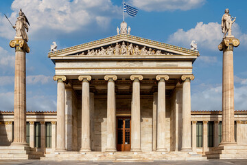 Fototapeta na wymiar Athens, Attica, Greece. Facade view of the National Academy of Athens neo classical building with the pediment on the theme of the birth of goddess Athena. Statues of Athena and Apollo