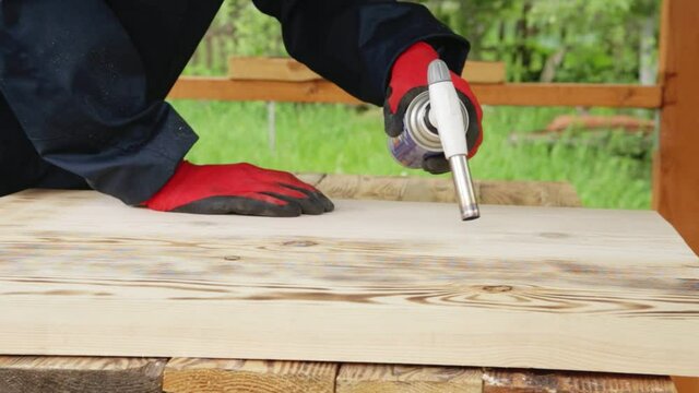 Firing wood with a gas burner for finishing. Firing technology, close-up, industrial