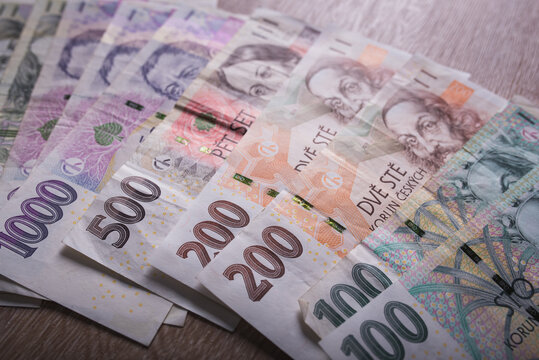 Close up on Czech money laying on the table. Different value of the Czech crown. Lots of money, lots of banknotes.