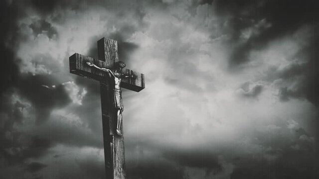 Jesus Christ crucified at Golgotha hill outside ancient Jerusalem. The crucifixion of Christ with stormy clouds in the sky. Vintage film look. 4K video