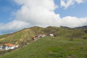 Fototapeta na wymiar Crimea. Mountain landscape with rural houses on the background of blue sky and beautiful clouds.