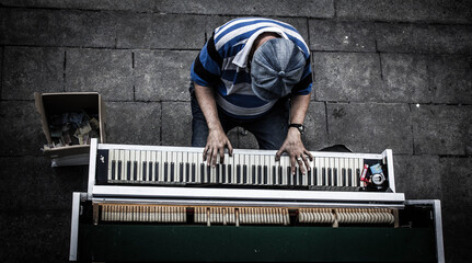 street musician on the piano view from above