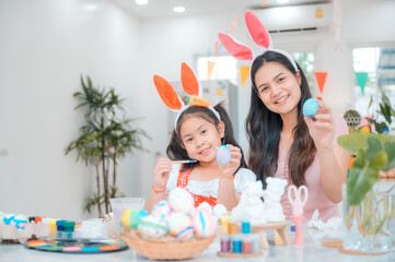 Obraz na płótnie Canvas young family people making easter egg in holiday at home, decoration background, spring colours rabbit tradition, children happy celebration art creative design with easter day