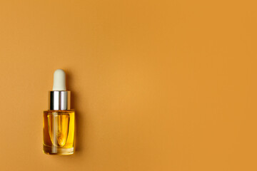 Glass white and yellow. bottles for oil, lotion, cream orange background. Natural cosmetics. Layout of the beauty salon branding.