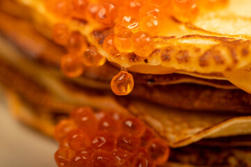 Traditional Russian pancakes with red salmon caviar. Shrovetide week of the meeting of spring.