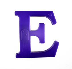 Plastic letter E of the English alphabet against white background, top view.