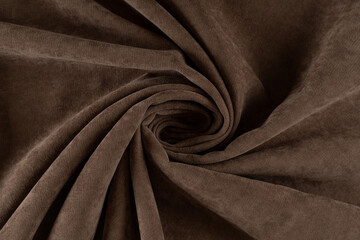 curtain fabric dark brown canvas, rolled into a spiral