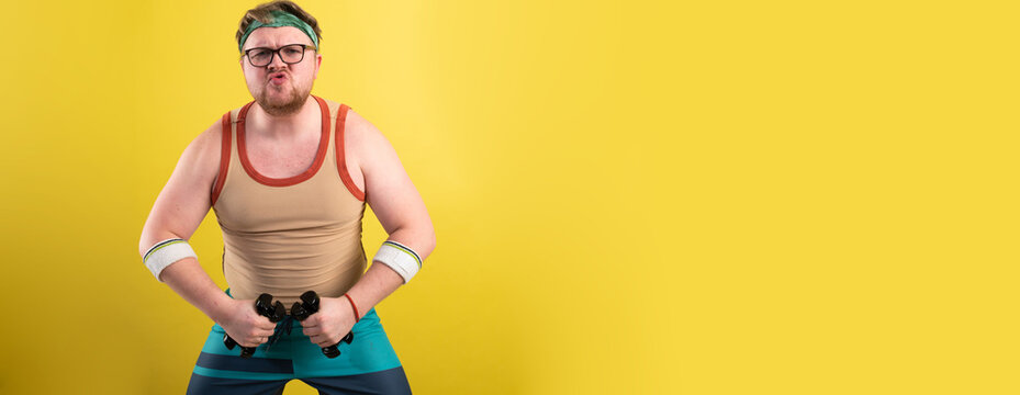 funny fat man doing exercises with dumbbells. Overweight. yellow background