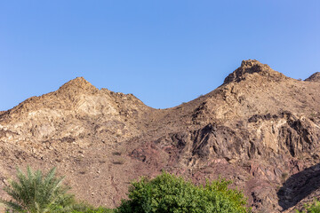 Hajar Mountains range with hiking trails landscape seen from Hatta town, United Arab Emirates.