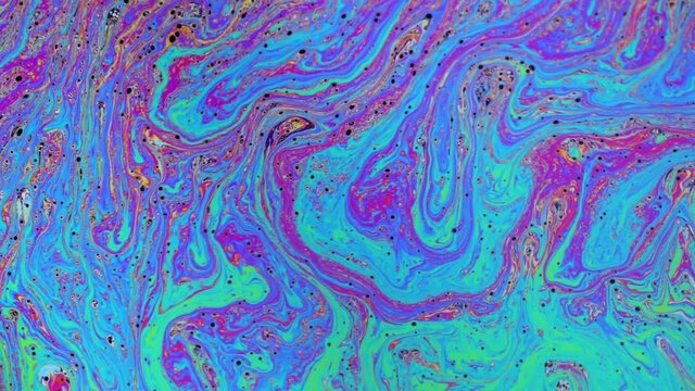 Psychedelic abstract colours and patterns reflecting on a soap bubble.