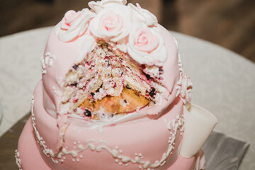 Stylish modern wedding cake. Beautiful dessert decorated with fresh flowers and greenery.