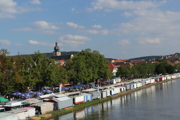 Fototapeta na wymiar riverside of the main in marktheidenfeld during laurenzi fair in summer